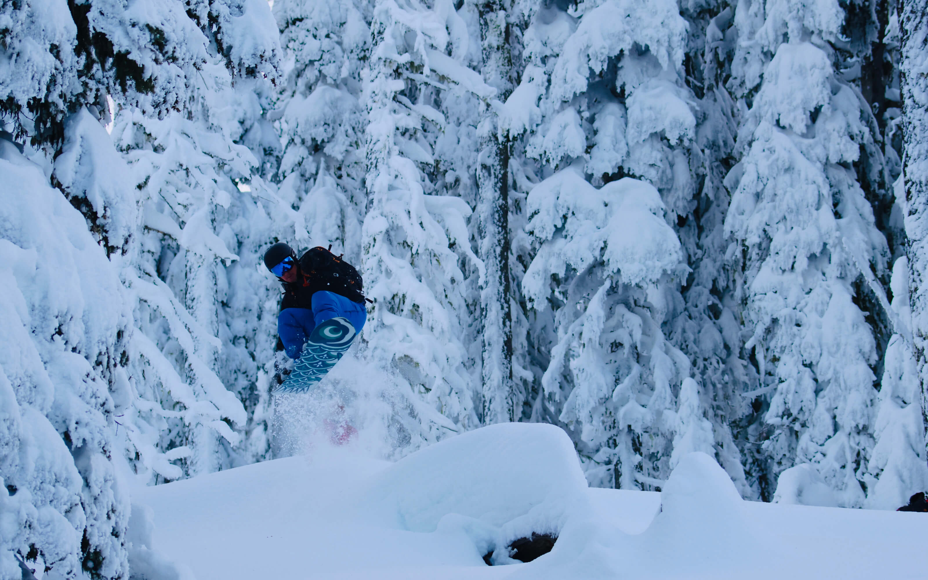 A snowboarder makes a jump