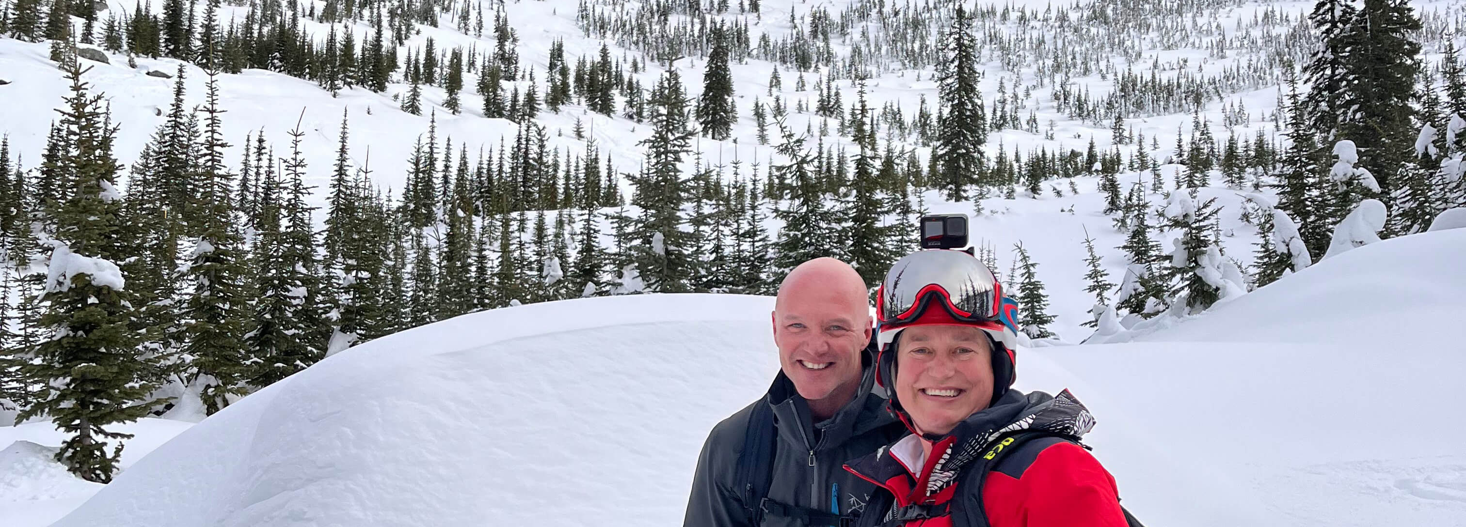 Two smiling skiers in the backcountry