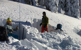 backcountry skiers digging snow pits