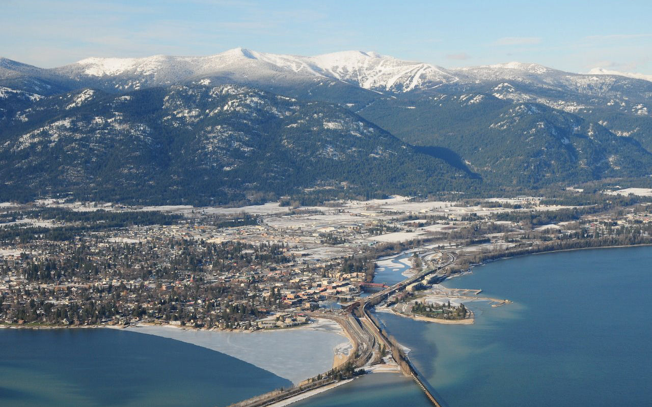Aerial of snowy town and mountains
