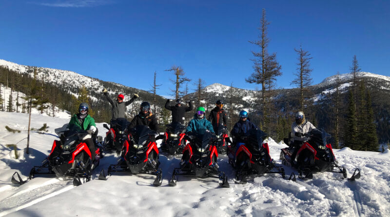 Posing with Polaris snowmobiles